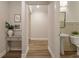 Hallway leading to bathroom featuring a modern vanity with stylish wainscotting at 714 Chipping Sparrow St, Canton, GA 30115