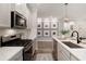 Stylish kitchen with stainless steel appliances, white backsplash, and wood floors at 714 Chipping Sparrow St, Canton, GA 30115