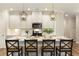 Beautiful kitchen with white cabinets, pendant lighting, and island seating at 714 Chipping Sparrow St, Canton, GA 30115