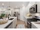Spacious kitchen featuring stainless steel appliances, light countertops and wood flooring at 714 Chipping Sparrow St, Canton, GA 30115