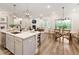 Open-concept kitchen with island seating and view of dining and living areas at 714 Chipping Sparrow St, Canton, GA 30115