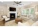 Cozy living room with fireplace, comfortable seating, and large windows at 714 Chipping Sparrow St, Canton, GA 30115