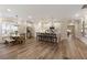 Open-concept kitchen, dining and living area with stainless appliances and hardwood floors at 714 Chipping Sparrow St, Canton, GA 30115