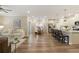 Open-concept living space with living, dining, and kitchen areas featuring wood floors at 714 Chipping Sparrow St, Canton, GA 30115