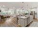 Open-concept living space with modern kitchen, dining area, and comfortable seating at 714 Chipping Sparrow St, Canton, GA 30115