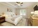 Spacious main bedroom with tray ceiling, large window and ensuite bath at 714 Chipping Sparrow St, Canton, GA 30115