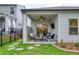 Covered patio with outdoor seating area and adjacent fenced yard at 714 Chipping Sparrow St, Canton, GA 30115