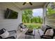 Covered patio with outdoor seating, ceiling fan, and view of the backyard at 714 Chipping Sparrow St, Canton, GA 30115