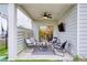 Covered patio with outdoor seating, ceiling fan, and privacy fence at 714 Chipping Sparrow St, Canton, GA 30115