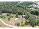 Expansive aerial view of a charming two-story home nestled among lush greenery and a winding road at 17 Hiram Way, Hiram, GA 30141