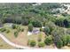 Expansive aerial view of the property showcasing mature trees, the lawn, and a charming home with a driveway at 17 Hiram Way, Hiram, GA 30141