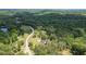 Beautiful aerial shot showcasing a home surrounded by verdant trees and a scenic road at 17 Hiram Way, Hiram, GA 30141