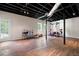 Finished basement with wooden floors, workout equipment, and natural light from windows, offering versatile space at 17 Hiram Way, Hiram, GA 30141