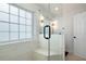 Bright bathroom showcasing a glass shower with a built-in bench, complemented by a large window for natural light at 17 Hiram Way, Hiram, GA 30141