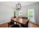 Bright dining room features hardwood floors, a modern light fixture, and views of the outdoor scenery at 17 Hiram Way, Hiram, GA 30141