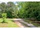 Gravel driveway winds through the trees, leading to a private home at 17 Hiram Way, Hiram, GA 30141