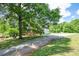 Driveway view showing a home, deck, trees, and ample parking space at 17 Hiram Way, Hiram, GA 30141