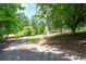 Driveway view showing a home, deck, trees, and lush greenery at 17 Hiram Way, Hiram, GA 30141