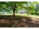 Two-story house with shutters and a porch, partially obscured by trees at 17 Hiram Way, Hiram, GA 30141