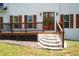 Front entrance boasts brick steps leading to a wooden deck, framed by double doors and shuttered windows at 17 Hiram Way, Hiram, GA 30141