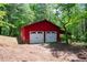 A two-car red garage with white doors sits surrounded by trees at 17 Hiram Way, Hiram, GA 30141