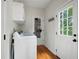 Functional laundry room features a washing machine and access to the backyard at 17 Hiram Way, Hiram, GA 30141