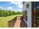 Relaxing side deck offers outdoor living space, complete with wooden railings, exterior lights, and a lawn view at 17 Hiram Way, Hiram, GA 30141