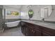 Bright bathroom featuring dual sinks, standalone tub, shower and large window offering natural light at 194 Beaverwood Ct, Lawrenceville, GA 30044