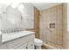 Bathroom with a granite vanity and an accessible tiled shower with a grab bar at 194 Beaverwood Ct, Lawrenceville, GA 30044