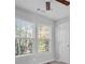 Light-filled bedroom with a ceiling fan and two windows at 194 Beaverwood Ct, Lawrenceville, GA 30044