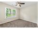 Bedroom with neutral walls, carpet floors, and a window offering a view of the outdoors at 194 Beaverwood Ct, Lawrenceville, GA 30044