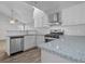 Modern kitchen featuring white cabinets, stainless steel appliances, and stone countertops at 194 Beaverwood Ct, Lawrenceville, GA 30044