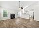 Cozy living room featuring a fireplace, hardwood floors, and an open floor plan leading into the kitchen at 194 Beaverwood Ct, Lawrenceville, GA 30044