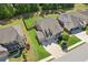 Expansive aerial view of a brick home, showcasing the well-maintained yard, and surrounding neighborhood at 2470 Crimson Downs Dr, Cumming, GA 30040
