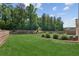 Spacious, well-manicured backyard featuring lush green grass and mature trees for privacy at 2470 Crimson Downs Dr, Cumming, GA 30040
