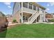 Charming backyard with a patio, stairs to upper deck, and lush green grass at 2470 Crimson Downs Dr, Cumming, GA 30040