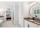 Bathroom with a granite vanity and a soaking tub across from a bedroom entrance at 2470 Crimson Downs Dr, Cumming, GA 30040