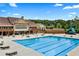 A large community pool has plenty of lounge chairs for relaxing, and a covered clubhouse for entertaining at 2470 Crimson Downs Dr, Cumming, GA 30040