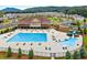 Beautiful community pool with a slide and kiddie pool area surrounded by lush landscaping and overlooking a neighborhood at 2470 Crimson Downs Dr, Cumming, GA 30040
