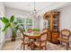 Bright dining room with stylish chandelier, decorative rug, and traditional china cabinet perfect for gatherings at 2470 Crimson Downs Dr, Cumming, GA 30040