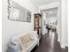 Elegant foyer featuring hardwood floors, decorative mirror, and a glimpse of the staircase and living spaces at 2470 Crimson Downs Dr, Cumming, GA 30040