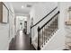 Hallway featuring hardwood floors, stairs, and access to the rest of this beautiful home at 2470 Crimson Downs Dr, Cumming, GA 30040