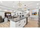 Open kitchen with an island and granite counters overlooks the living and dining areas at 2470 Crimson Downs Dr, Cumming, GA 30040