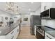 Modern kitchen with stainless appliances, granite counters and a light wood floor at 2470 Crimson Downs Dr, Cumming, GA 30040