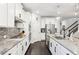 A gourmet kitchen featuring white cabinets, stainless steel appliances, and granite countertops for a modern touch at 2470 Crimson Downs Dr, Cumming, GA 30040
