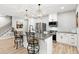 Bright kitchen boasts stainless steel appliances and a granite island with barstool seating at 2470 Crimson Downs Dr, Cumming, GA 30040
