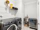 A functional laundry room equipped with a washer, dryer, sink, and beverage refrigerator at 2470 Crimson Downs Dr, Cumming, GA 30040