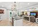 Kitchen with an island opens up to a living room with modern furniture at 2470 Crimson Downs Dr, Cumming, GA 30040