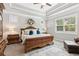 Serene main bedroom with tray ceiling, plush bedding, and a calming color scheme for a peaceful ambiance at 2470 Crimson Downs Dr, Cumming, GA 30040
