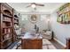 Cozy home office with custom built-ins, hardwood floors, and a comfortable seating area at 2470 Crimson Downs Dr, Cumming, GA 30040